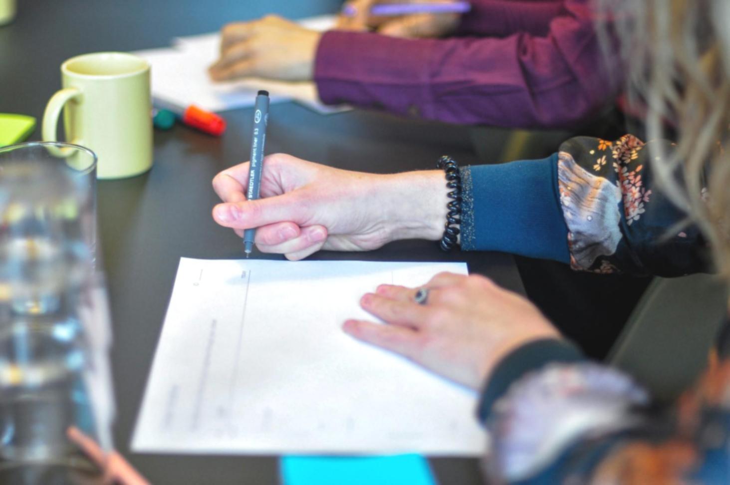 Students reviewing financial valuation techniques in classroom setting